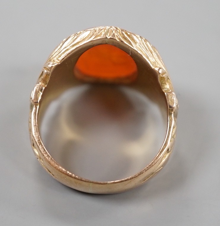 An early 20th century yellow metal and intaglio carnelian set signet ring, the matrix carved with the bust of a Roman soldier, with carved setting and shank, size M, gross weight 9.6 grams.